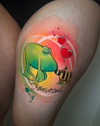 Get a whimsical illustrative watercolor tattoo of a frog toy by Cloto.tattoos for a playful and vibrant addition to your body art collection.
