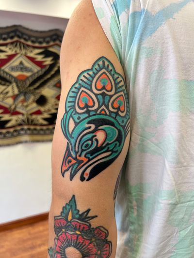 Experience the bold beauty of a peacock in an illustrative and ignorant style by artist Rich Phipson. Stand out with this vibrant and unique tattoo design.