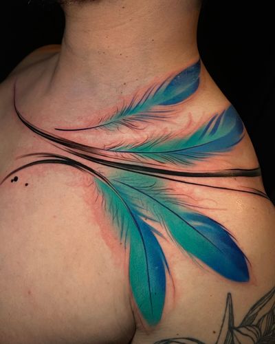Get a stunning watercolor feather tattoo on your neck by Cloto.tattoos for a unique and artistic look.