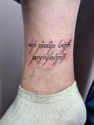 Get a perfectly sized small lettering tattoo on your ankle by the skilled hand of Jonathan Glick. Minimalist yet meaningful design.