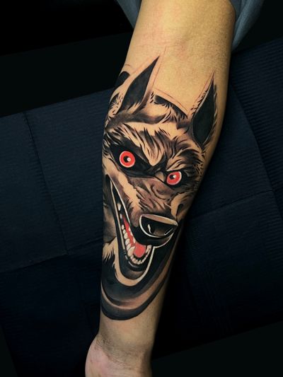 Vibrant new school style wolf tattoo on lower arm by Cloto.tattoos. Bold lines and bright colors bring this fierce wolf to life.
