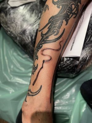 Get a stunning blackwork match tattoo done by the talented artist Frankie Brown. Unique and detailed design for tattoo enthusiasts.