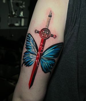 Unique tattoo design featuring a butterfly and a sword, done by Cloto.tattoos. Perfect blend of beauty and strength.