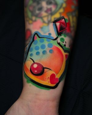 Get a whimsical and vibrant watercolor moogle tattoo inspired by Final Fantasy. Expertly done by Cloto.tattoos.