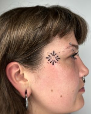 Elegant flower and pattern design by Indigo Forever Tattoos, perfect for a unique side face placement.