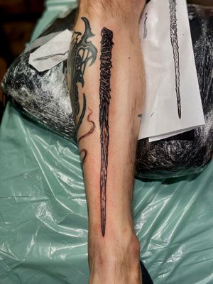 Get a unique blackwork stick, club, stake tattoo by artist Frankie Brown. Bold and illustrative design.