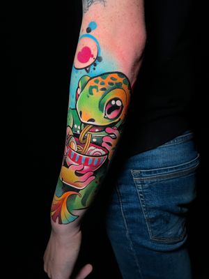 Get a quirky new school tattoo of ramen and a lizard on your lower arm by Cloto.tattoos. A unique and fun design that will surely stand out!