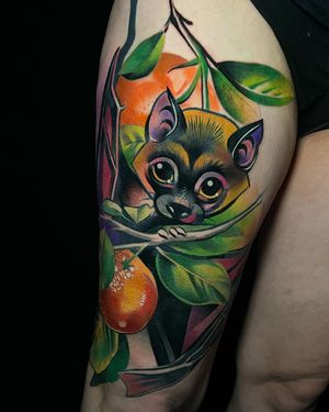 Vibrant new school design featuring playful bats and an orange tree by Cloto.tattoos on the thigh.