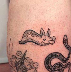 Unique and bold tattoo featuring a slug, created by Jonathan Glick in illustrative style.
