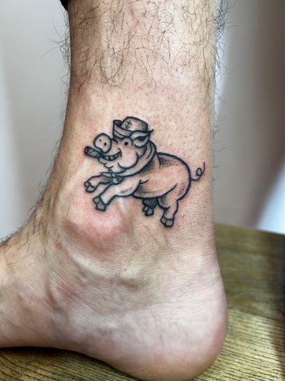 Classic traditional tattoo featuring a sailor and a pig, done with a touch of ignorance by the talented artist Jonathan Glick.
