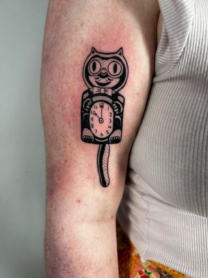 Enjoy this playful tattoo by Jonathan Glick featuring a cat and clock in an illustrative, ignorant style.