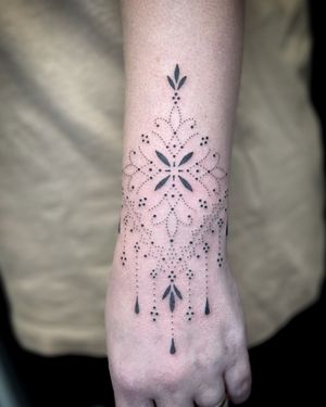 Adorn your wrist with a stunning ornamental pattern by Indigo Forever Tattoos.