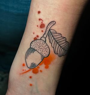 Express your quirky side with this vibrant watercolor nut tattoo by Cloto.tattoos. Unique and eye-catching!