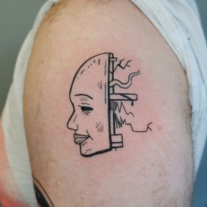 Dive into the future with this bold and edgy illustrative tattoo by Jonathan Glick. A stunning robot face design that will make you stand out.
