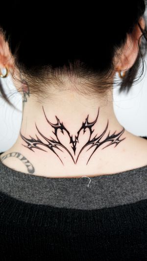 Experience the bold elegance of blackwork and black & gray styles with this intricate pattern tattoo on your neck by renowned artist Jacky Yang.