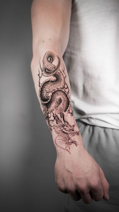 Experience the power and grace of a traditional Japanese dragon in this striking tattoo design by renowned artist Jacky Yang.
