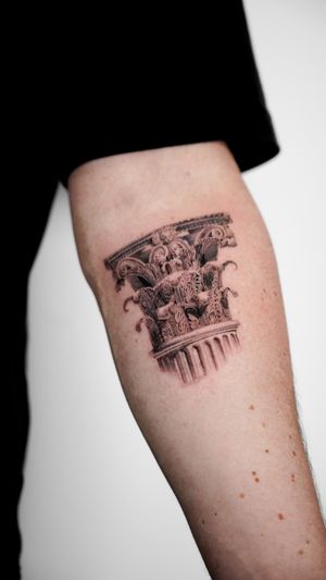 Elegant fine line and micro-realism tattoo of a Greek column, showcasing intricate architecture on the forearm. Expertly done by artist Jacky Yang.