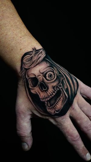 Embrace edgy neo-traditional style with a detailed skull design by talented artist Miss Vampira. Make a statement on your hand!