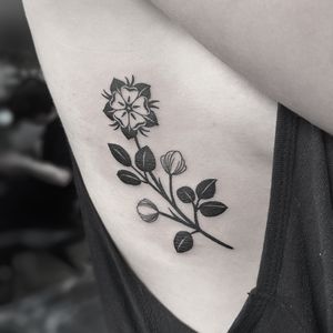 Beautiful blackwork tattoo featuring a Tudor rose flower, expertly done by Oliver Whiting.