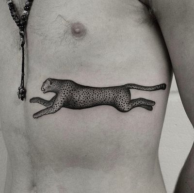 Unique dotwork and illustrative tattoo featuring a fierce leopard and cheetah design by artist Oliver Whiting.