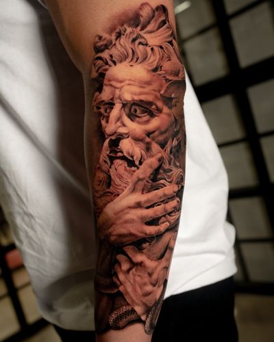 Capture the power of the sea with this stunning black and gray realistic Poseidon statue tattoo by Abel Lopez.
