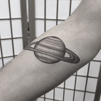 Illustrative dotwork tattoo of Saturn, created by artist Oliver Whiting. A unique celestial design for space enthusiasts.