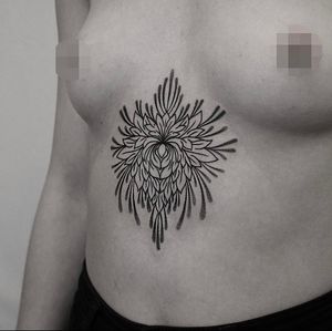 Discover the beauty of dotwork with a intricate flower mandala design by Oliver Whiting. Perfect for those seeking a unique and detailed tattoo.