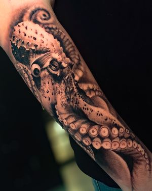 Experience the realism and intricate details of this black and gray octopus tattoo by talented artist Abel Lopez.