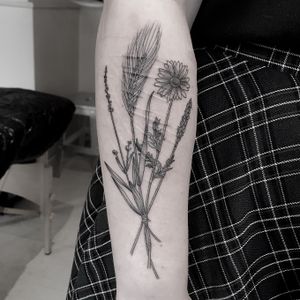 Get inked with a stunning dotwork and fine line illustrative tattoo by Oliver Whiting, featuring a beautiful bundle of botanical flowers.