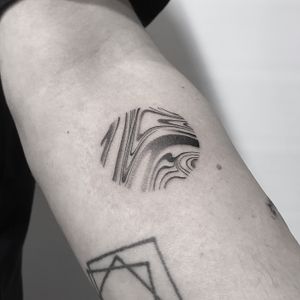 Unique dotwork design by Oliver Whiting featuring abstract, wavy lines for a mesmerizing and eye-catching tattoo.