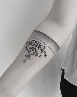 Unique dotwork illustrative arm band tattoo featuring intricate floral patterns done by talented artist Oliver Whiting.