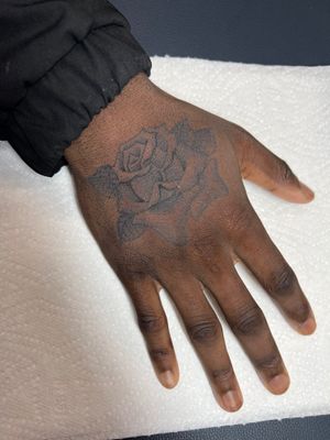 Check out this beautiful illustrative black and gray rose tattoo by Clayton Jeremiah, designed specifically for dark skin tones.