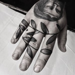 Unique dotwork style tattoo of vine and leaves by renowned artist Oliver Whiting