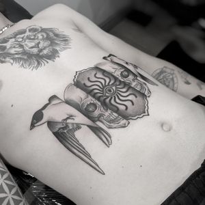 Unique tattoo by Oliver Whiting combining dotwork, illustrative style and surrealism with swallow, skull, evil eye motifs.