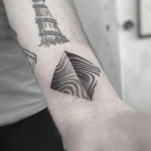 Unique dotwork design by Oliver Whiting featuring a geometric pyramid with wavy elements.