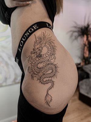Experience the ancient power of a Japanese dragon etched onto your hip by the talented artist Ion Caraman. Let this mythical creature symbolize strength and protection for you.