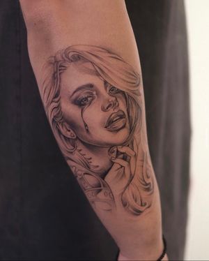Stunning black and gray tattoo of a beautiful girl, done by Ion Caraman, combining chicano and realism styles.