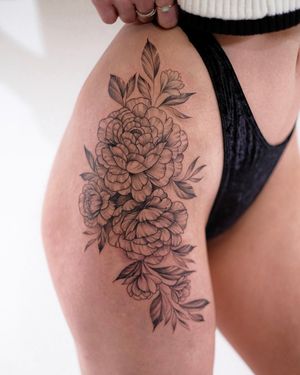 Elegant flower design on the hip, created by the talented artist Ion Caraman. A beautiful and feminine choice for body art.