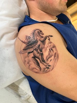 Discover the artistry of Ion Caraman through this black and gray, dotwork, micro_realism tattoo featuring the legendary Pegasus and Bellerophon.