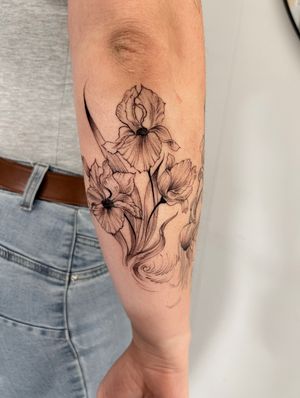 Adorn your lower arm with a beautiful bouquet of flowers by Ion Caraman. A perfect blend of nature and artistry.