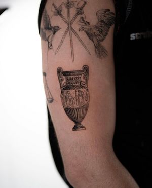 Experience intricate artistry with this micro-realism and illustrative tattoo of a Greek vase by Ion Caraman.