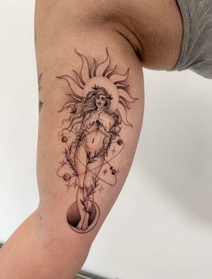 Capture the beauty of the cosmos with this intricate dotwork tattoo featuring a celestial goddess surrounded by sun, moon, planets, and space elements. Created by the talented artist Ion Caraman.