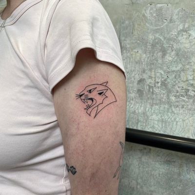 Ignite your wild side with this fine line panther tattoo, expertly crafted by talented artist Charlie Macarthur.