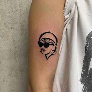 Get a sleek and stylish illustrative tattoo of a woman inspired by your favorite movie, expertly done by Charlie Macarthur.