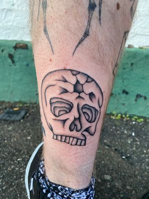 Get a unique illustrative skull tattoo by the talented artist Charlie Macarthur, perfect for a bold and edgy look.