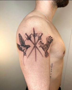 Get a stunning black and gray tattoo featuring a swallow, eagle, and sword by the talented artist Ion Caraman.