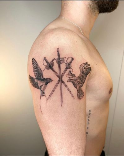 Get a stunning black and gray tattoo featuring a swallow, eagle, and sword by the talented artist Ion Caraman.