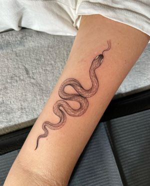 Discover the intricate beauty of this illustrative snake tattoo, expertly crafted by Ion Caraman with fine line details.