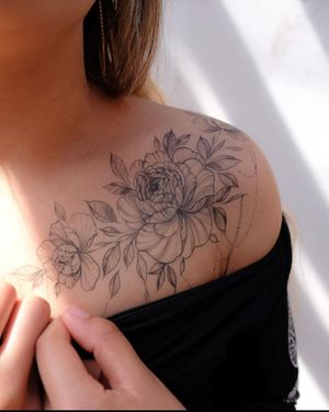 Beautiful flower motif tattoo by Ion Caraman, perfect for shoulder placement.