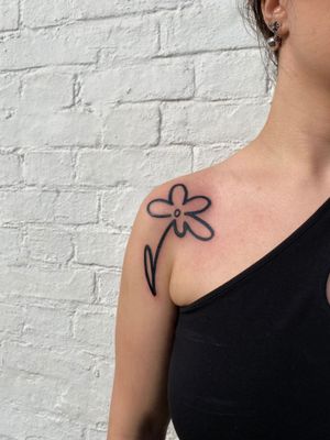 Get mesmerized by the bold and beautiful flower design in this ignorant style tattoo expertly crafted by artist Charlie Macarthur.